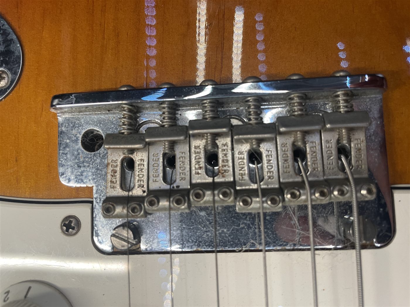 Rusty Stratocaster bridge saddles before cleanup